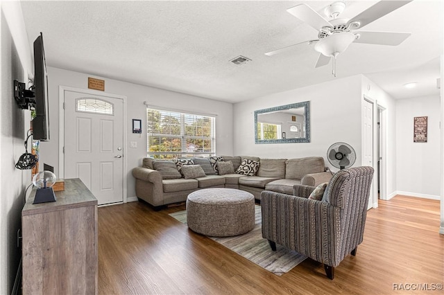 4325 NE 33rd Ave, Ocala, FL 34479 - living room featuring wood finished floors, a ceiling fan, and a textured ceiling