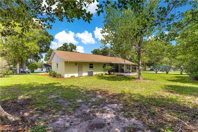 4325 NE 33rd Ave, Ocala, FL 34479 - rear view of house featuring a sunroom and a lawn