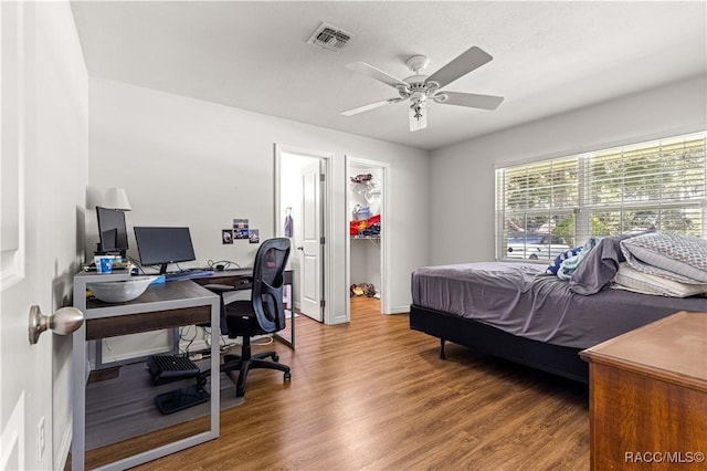 4325 NE 33rd Ave, Ocala, FL 34479 - bedroom featuring an office area, wood finished floors, a walk in closet, a ceiling fan, and a closet