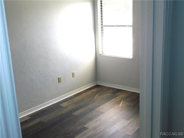 spare room with dark hardwood / wood-style flooring