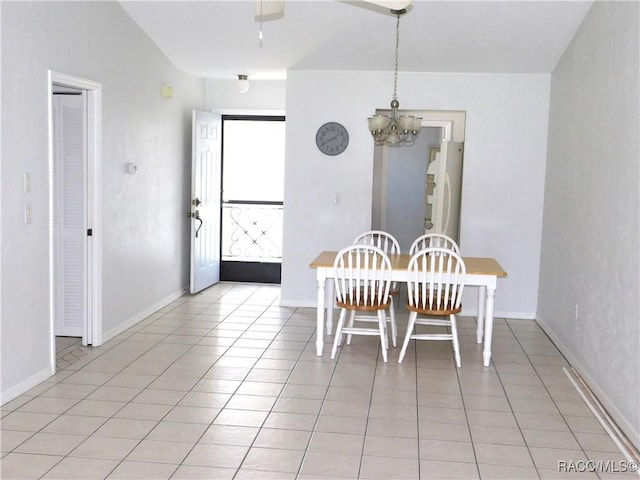 dining room with light tile patterned floors and a chandelier