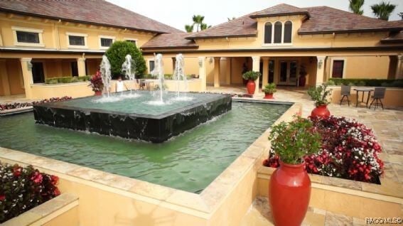 view of swimming pool with pool water feature