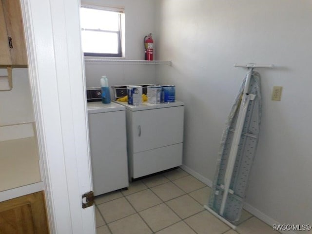 washroom with separate washer and dryer and light tile patterned flooring