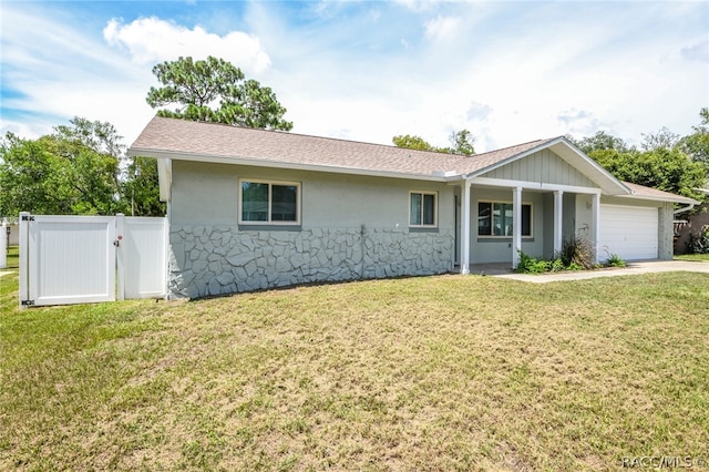 ranch-style home featuring a garage and a front lawn