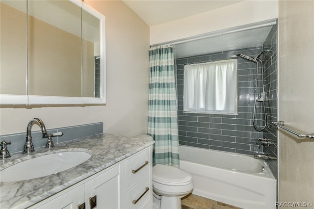 full bathroom with shower / bath combo with shower curtain, vanity, and toilet