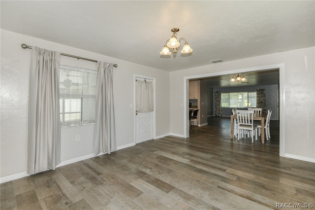 interior space featuring dark hardwood / wood-style flooring and a notable chandelier