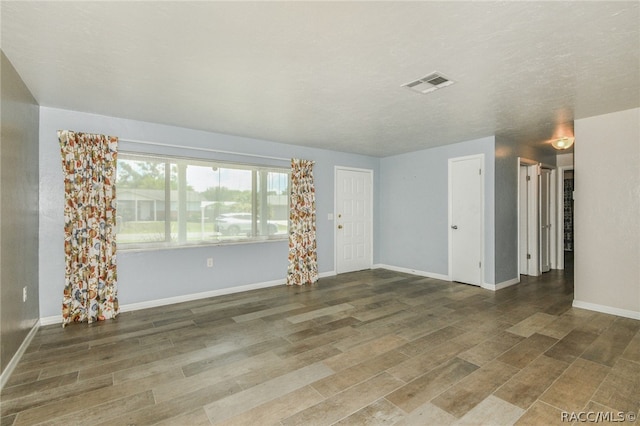 unfurnished room featuring dark wood-type flooring