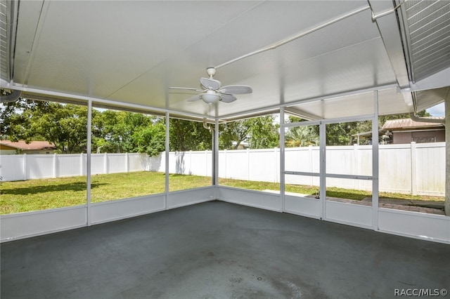 unfurnished sunroom with ceiling fan