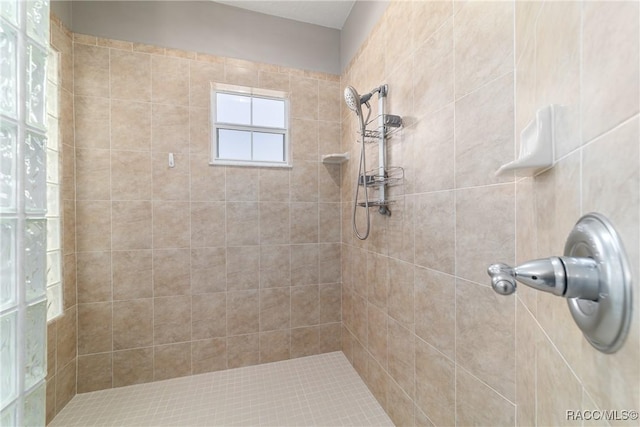 bathroom with a tile shower