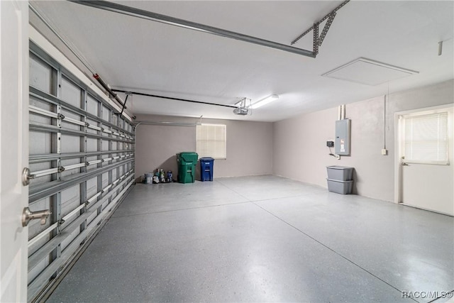 garage featuring electric panel and a garage door opener