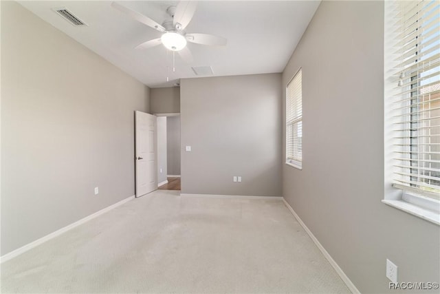 unfurnished room with plenty of natural light, baseboards, and a ceiling fan