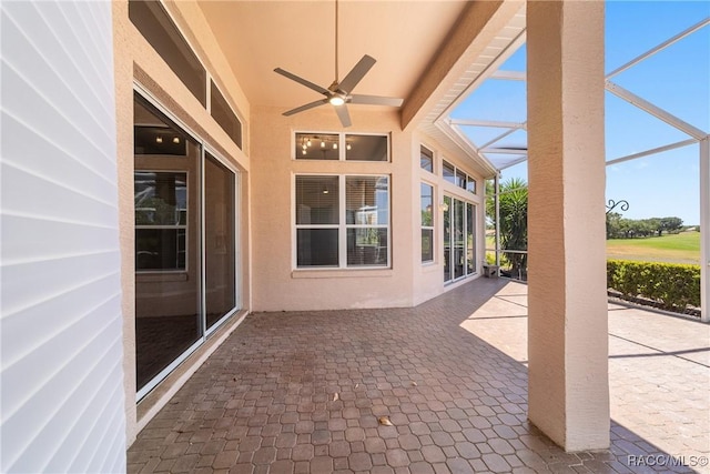 view of patio featuring a ceiling fan and a lanai