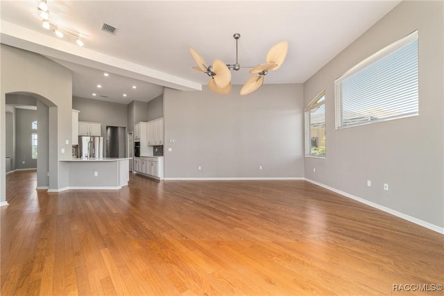23 W Mickey Mantle Path, Hernando, FL 34442 - unfurnished living room with arched walkways, healthy amount of natural light, a chandelier, light wood finished floors, and recessed lighting