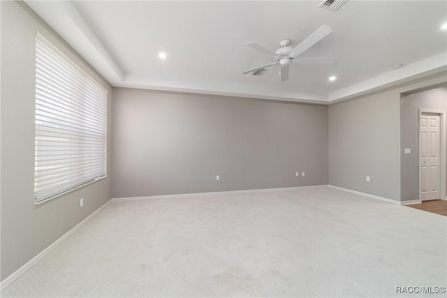 carpeted empty room featuring baseboards, a ceiling fan, visible vents, and recessed lighting