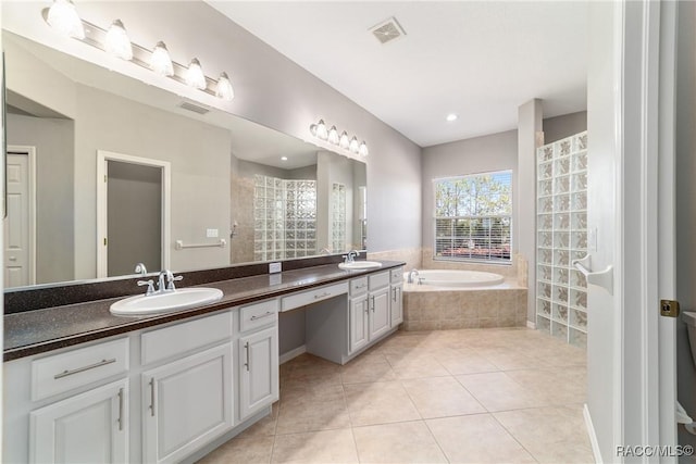 bathroom featuring a sink, a bath, visible vents, and tile patterned floors