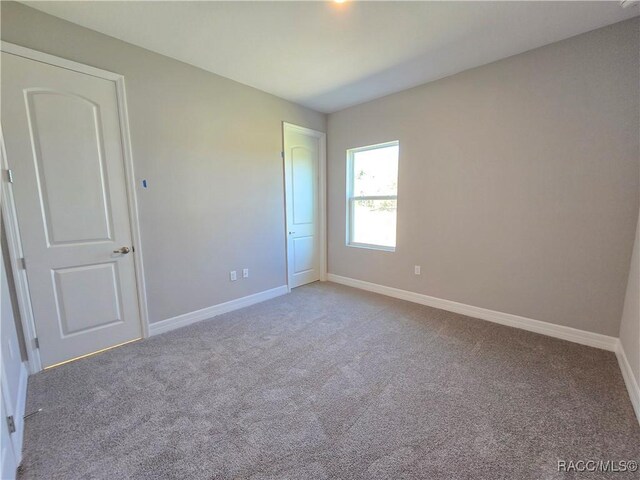 2645 N Annapolis Ave, Hernando, FL 34442 - unfurnished bedroom featuring carpet floors and baseboards