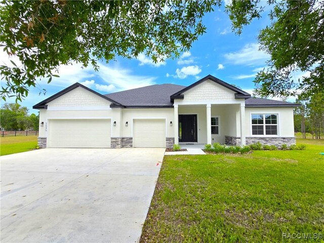 2645 N Annapolis Ave, Hernando, FL 34442 - view of front of house with stone siding, a garage, concrete driveway, and stucco siding