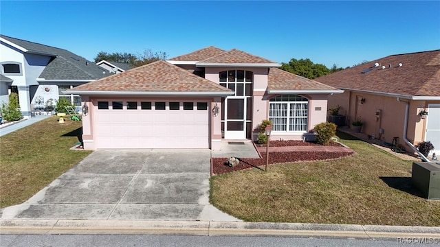 view of front of property with a front lawn and a garage