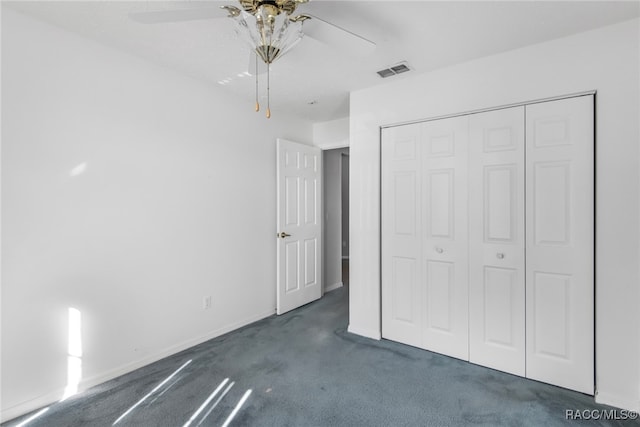 unfurnished bedroom with ceiling fan, a closet, and dark colored carpet