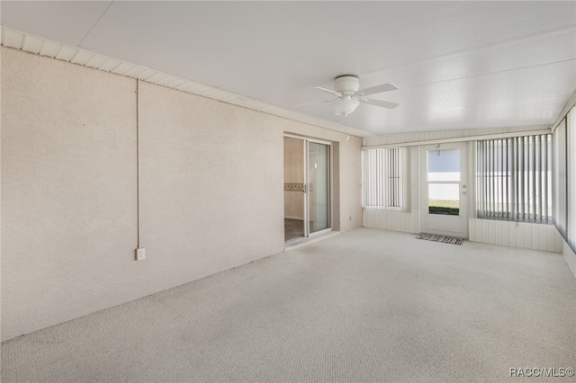 unfurnished sunroom featuring ceiling fan