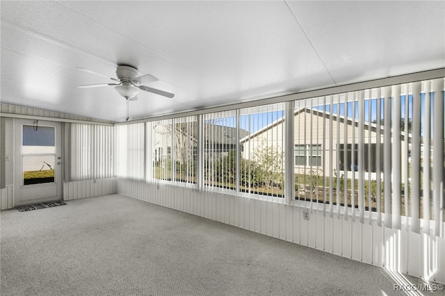 unfurnished sunroom with ceiling fan