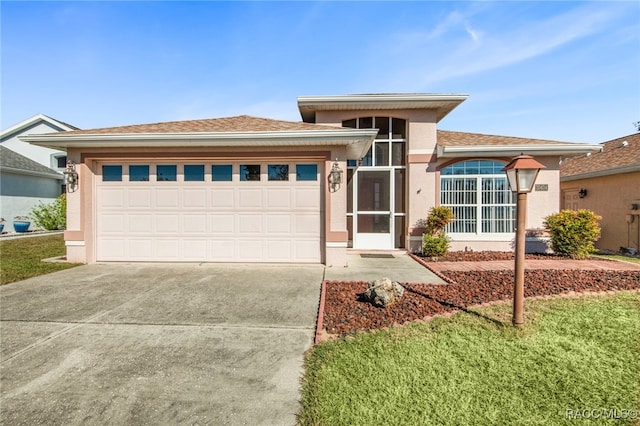 view of front of property featuring a garage and a front yard