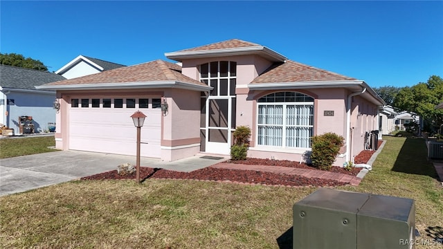 view of front of house featuring a garage and a front yard