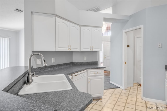 kitchen featuring dishwasher, light tile patterned flooring, white cabinetry, and sink