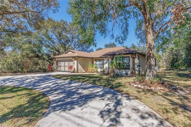 single story home with a garage and a front yard