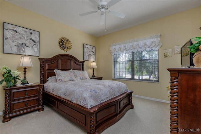 bedroom with ceiling fan and light colored carpet