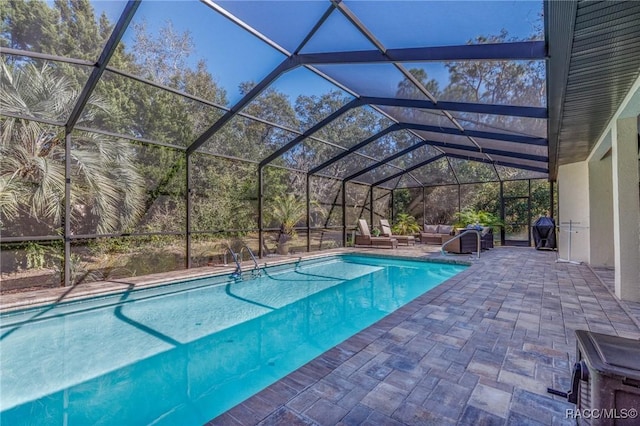 view of swimming pool with area for grilling, a lanai, and a patio