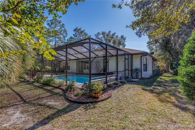 exterior space with glass enclosure and a yard