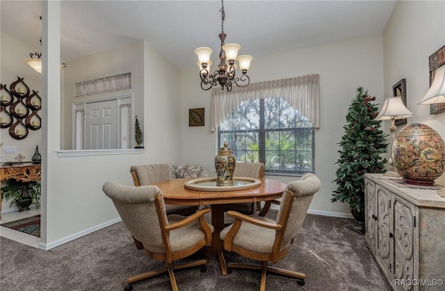 dining area featuring dark carpet and an inviting chandelier