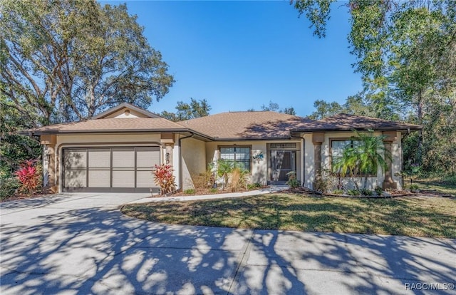 view of front of home featuring a garage and a front lawn