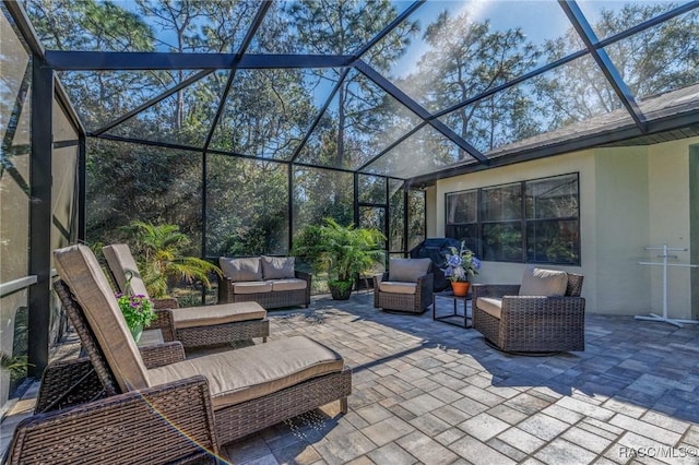 view of patio / terrace featuring glass enclosure and outdoor lounge area