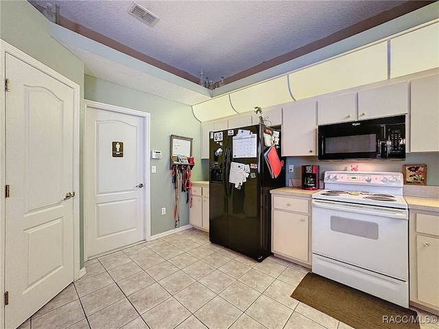 kitchen featuring white cabinets, light tile patterned flooring, black appliances, and a textured ceiling