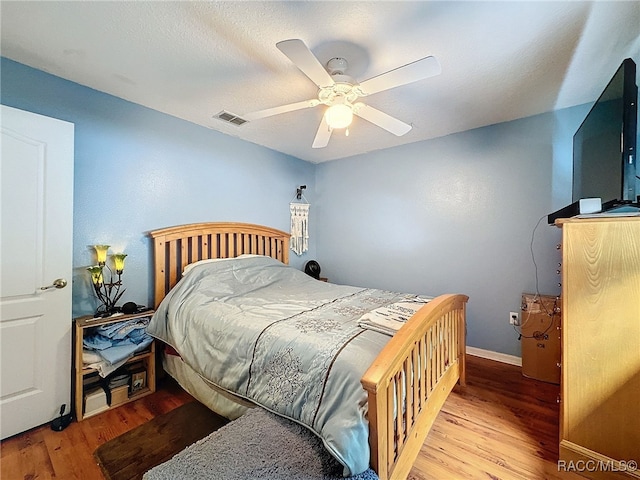 bedroom featuring ceiling fan and light hardwood / wood-style flooring