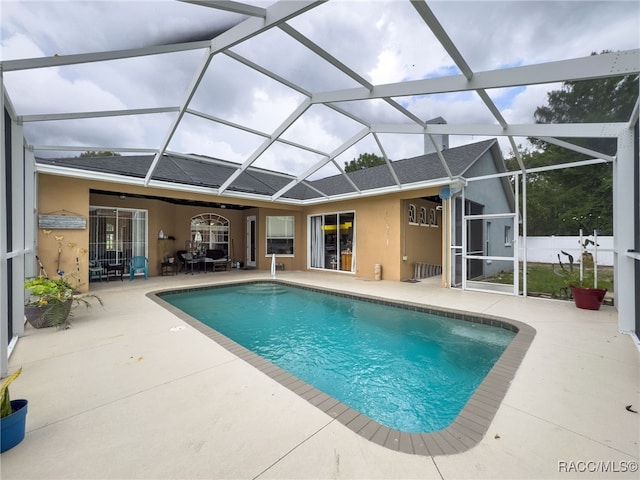 view of pool with a patio area and a lanai