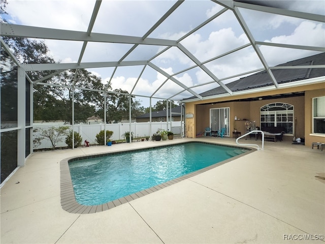 view of swimming pool with a patio and glass enclosure