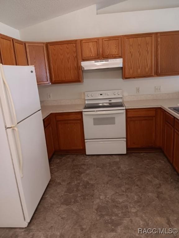 kitchen featuring white appliances and vaulted ceiling