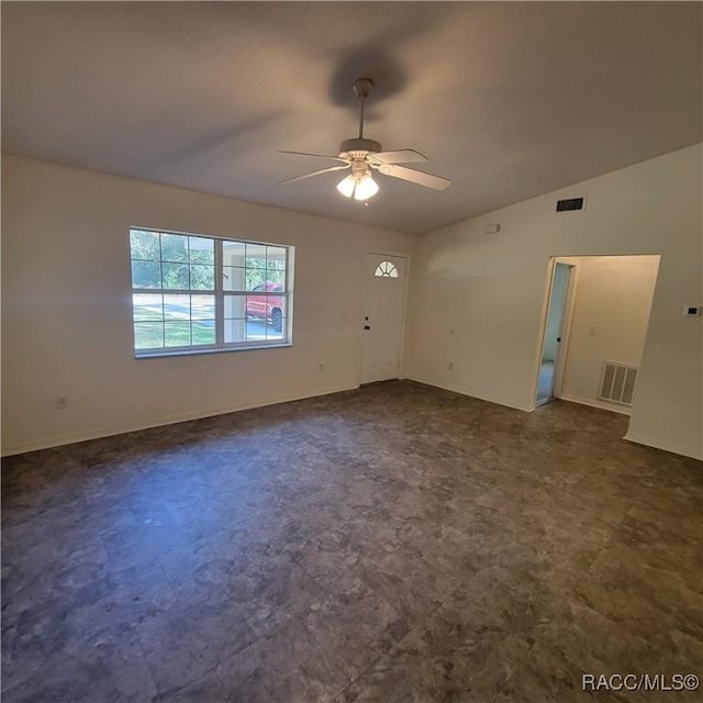 spare room with ceiling fan and vaulted ceiling