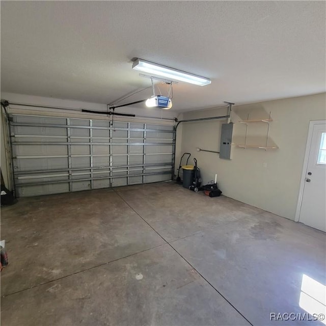 garage with electric panel and a garage door opener