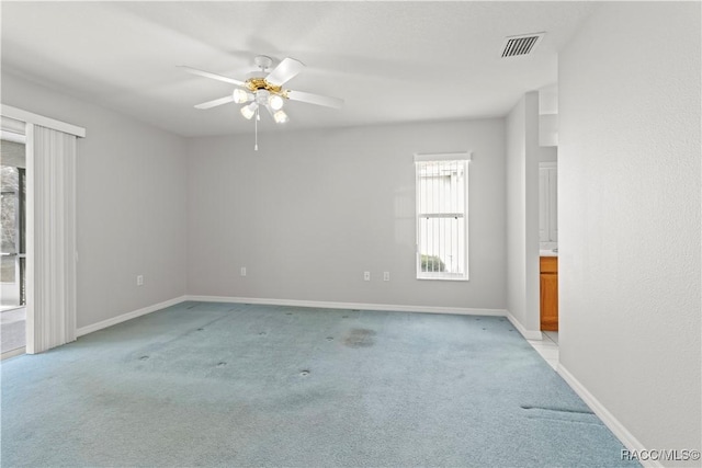 empty room with light colored carpet and ceiling fan