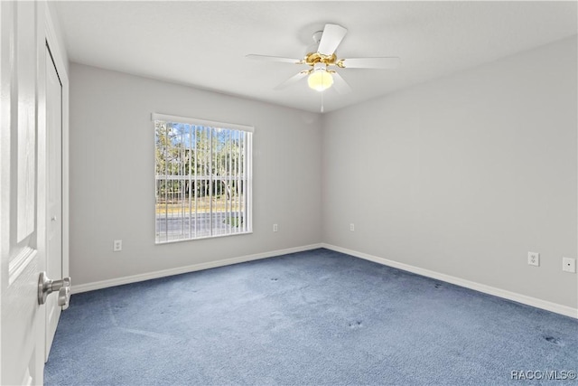 spare room featuring ceiling fan and carpet floors