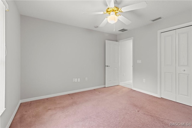 unfurnished bedroom with carpet flooring, ceiling fan, and a closet