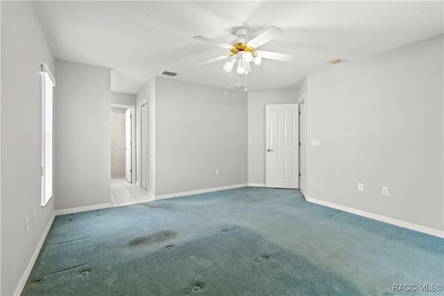 spare room with ceiling fan and light carpet