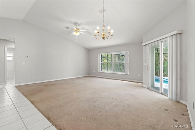 carpeted empty room with lofted ceiling and ceiling fan with notable chandelier