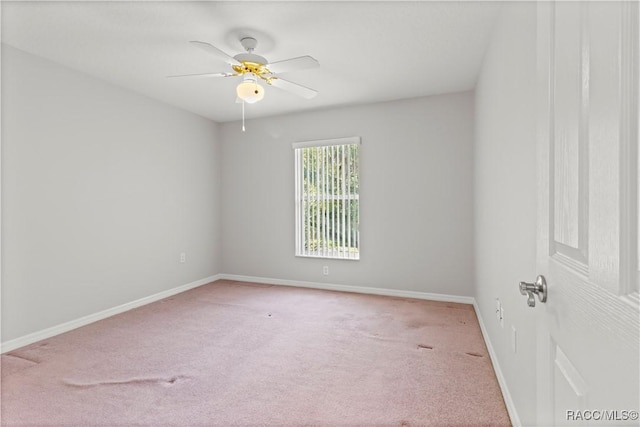 unfurnished room featuring light colored carpet and ceiling fan