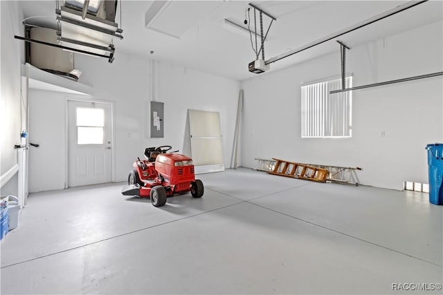 garage with a garage door opener and electric panel