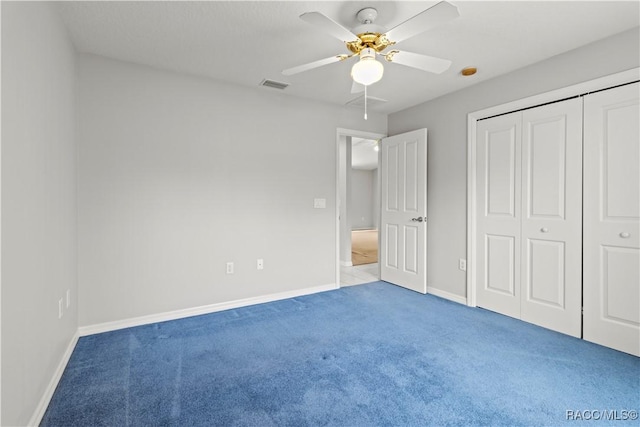 unfurnished bedroom with a closet, ceiling fan, and carpet